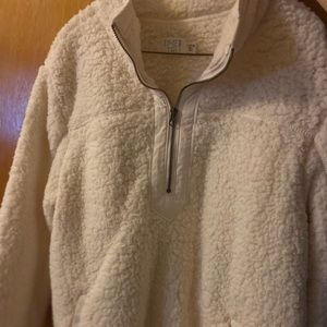 Large white Sherpa pullover jacket that half zippers.